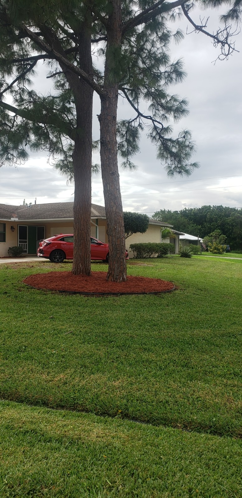 A red car parked in front of a house