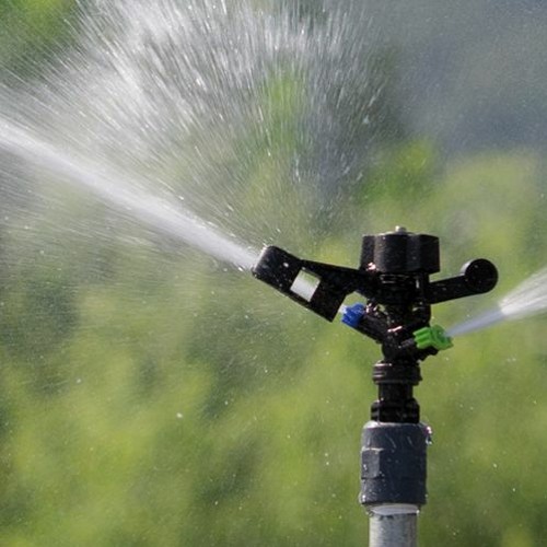 A fire hydrant spewing water into the air